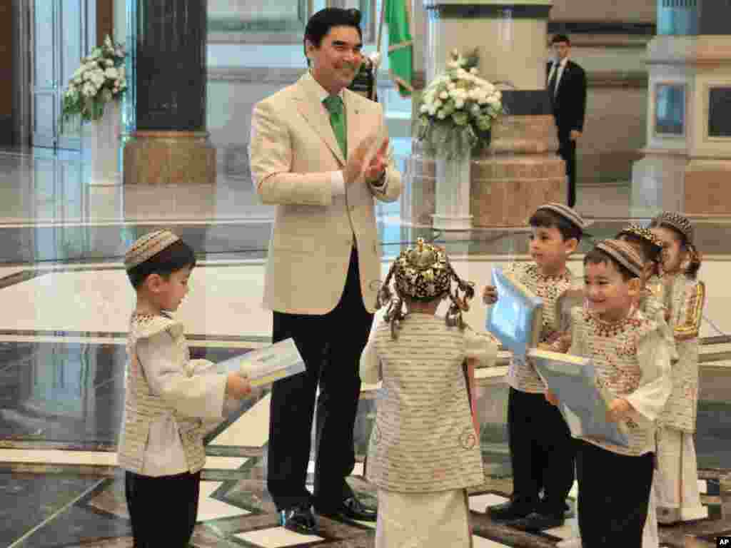 Keeping it clean: Berdymukhammedov gives presents to children during the opening ceremony of a new presidential palace in Ashgabat last year. 