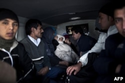 A group of Afghan and Palestine migrants is seen inside a police van in Nea Vissa, Greece. (file photo)