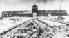 This 1945 photo shows the entry to the concentration camp at Auschwitz-Birkenau in Poland, with snow covered rail tracks leading to the camp.