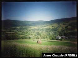 Hay bales and farmland around a village in the Carpathians.