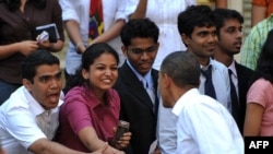 U.S. President Barack Obama shakes hands with students at St. Xavier College in Mumbai today.