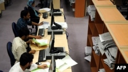 Afghan election workers count results at the Independent Election Commission headquarters in Kabul.