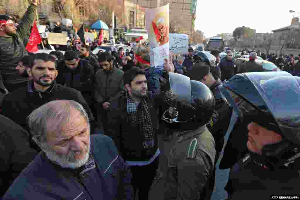 Iranian demonstrators hold posters bearing the image of slain military commander Qasem Soleimani in front of the British Embassy in Tehran on January 12. About 200 protesters chanted &quot;Death to Britain&quot; as they rallied outside the mission. The day before, British Ambassador Rob Macaire was briefly arrested for attending a memorial for the victims of&nbsp;Ukraine International Airlines Flight PS752.