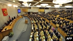 Deputies listen to the national anthem during the first session of Russia's new State Duma on December 21.