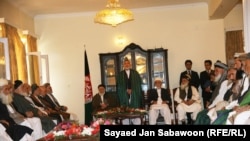 Afghan President Hamid Karzai (standing) speaks with members of the High Peace Council at its inauguration in Kabul, on October 7. One former Taliban leader describes the council as a good first step toward peace.