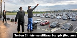 Danish group Malk de Koijn on stage holds a drive-in concert at a parking lot outside Copenhagen Airport on May 30.