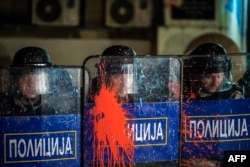 Riot police stand guard in front of the Ministry of Culture in Skopje on April 18.