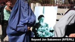 Supporters carry portraits of Burhanuddin Rabbani during a gathering in Kabul to remember him.