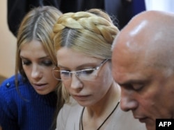 Yulia Tymoshenko (center) is surrounded by her daughter, Yevhenia, and her husband, Oleksandr, in a Kyiv court in October.