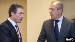 NATO Secretary-General Anders Fogh Rasmussen (left) talks with Russian Foreign Minister Sergei Lavrov about renewed cooperation between Russia and NATO.