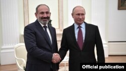 Russian President Vladimir Putin (right) hosted Armenian Prime Minister Nikol Pashinian at the Kremlin on September 8, the two leaders' third such meeting.