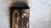 An ethnic Uzbek man walks through the ruins of his house, which was destroyed during ethnic clashes in Osh, on June 17.