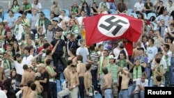 Karpaty Lviv supporters hold up a German Nazi flag at a soccer match against Dynamo Kyiv in 2007.