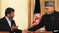 Iran President Mahmud Ahmadinejad (left) with his Afghan counterpart, Hamid Karzai, in Kabul on March 10