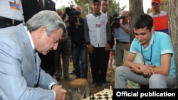 Armenian President Serzh Sarkisian plays chess during a visit to a youth camp in Lake Sevan in August.