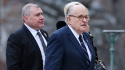 Rudy Giuliani (center), the personal attorney of U.S. President Donald Trump, walks with Lev Parnas in December 2018.