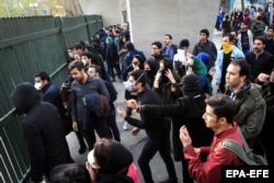 Iranian students clash with riot police during an antigovernment protest at Tehran University on December 30.