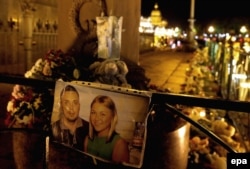 Photos of victims of the Sinai crash are shown next to flowers and candles at Dvortsovaya Square in St. Petersburg, where the doomed flight was headed.