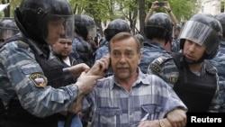 Riot police detain rights activist Lev Ponomaryov during an unsanctioned protest in Moscow in May 2012.