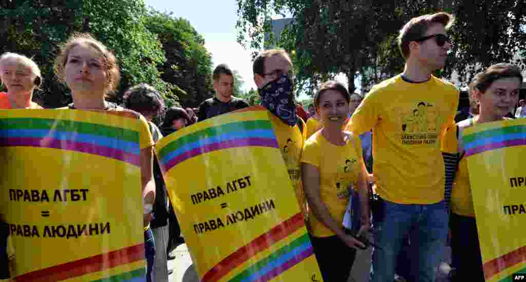 Activists carry placards saying &quot;Lesbian and gay rights are human rights&quot; during the gay-pride parade in the Ukrainian capital.&nbsp;