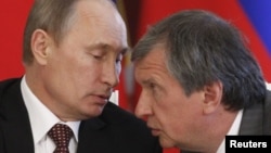 Russian President Vladimir Putin (left) with his "right-hand man" Igor Sechin, who is one of those targeted by the latest round of U.S. sanctions. 