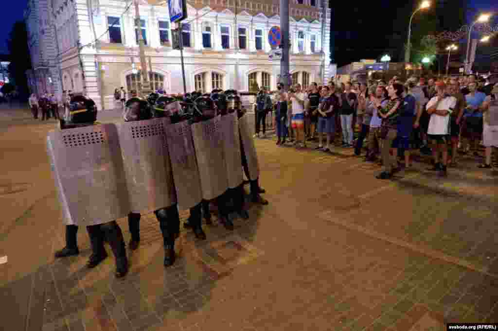 Riot police and anti-government protesters in Homel.