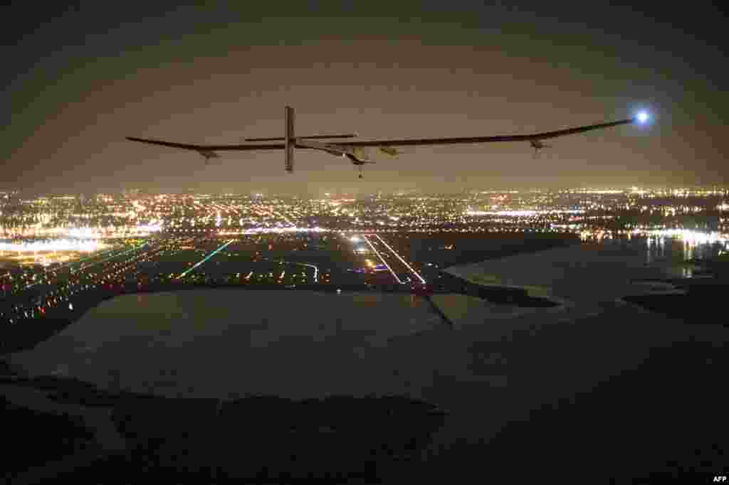 A handout photo of the &quot;Solar Impulse HB-SIA&quot; aircraft with pilot Andre Borschberg aboard as it approaches its final destination of JFK airport in New York in what Borschberg called a &quot;huge success for renewable energy.&quot; (AFP/SolarImpulse/Jean Revillard)