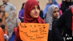 Pakistani students of the private PakTurk International Schools and Colleges demonstrate in Islamabad against the closing of their schools on November 17.