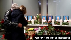 Relatives of the flight crew of the Ukrainian airliner mourn at Boryspil International Airport outside Kyiv.