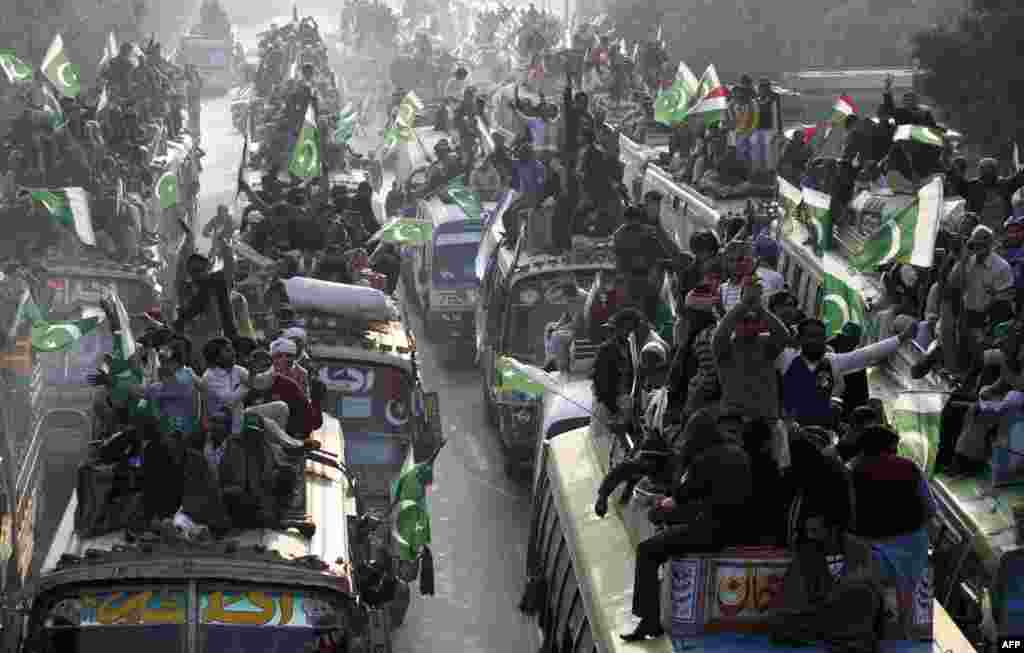 Supporters of religious leader Tahir-ul Qadri gather in Lahore on January 13 to take part in the &quot;Caravan of Democracy March.&quot;