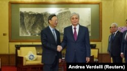 Chinese Communist Party Politiburo member Yang Jiechi (left) shakes hands with Kazak President Qasym-Zhomart Toqaev in Diaoyutai State Guesthouse, Beijing, on September 11.