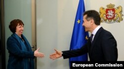 Georgian Prime Minister Bidzina Ivanishvili meets with EU foreign-policy chief Catherine Ashton in Tbilisi on November 26. "Investigations into past wrongdoings must be -- and must be seen to be -- impartial, transparent, and in compliance with due process,” Ashton said.