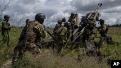 Ukrainian troops prepare to fire a U.S.-supplied M777 howitzer at Russian positions in the Kharkiv region in July. Will recent successes stymie Kyiv's requests for more arms?