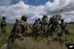 Ukrainian soldiers prepare to fire at Russian positions with a U.S.-supplied M777 howitzer in Ukraine's Kharkiv region on July 14, 2022.