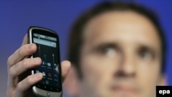 Google's Mario Queiroz holds up the Nexus One smartphone at Google headquarters in Mountain View, California.