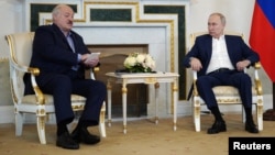 Russian President Vladimir Putin (right) meets with Belarusian ruler Alyaksandr Lukashenka in St. Petersburg on July 23.