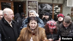 Disqualified presidential candidate Alla Dzhioyeva speaks to the media outside the Central Election Commision building in Tskhinvali on November 30.