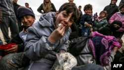 Syrians fleeing the northern embattled city of Aleppo are pictured in a camp near the Turkish border.