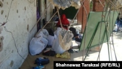 Students and a teacher of a destroyed girls school in Bajaur Agency hide their faces from the camera.