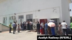 People in Ashgabat wait in line to buy food in a state shop.