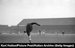 Dynamo Moscow goalkeeper Aleksei Khomich kicks the ball up-field at Cardiff City's Ninian Park ground during his team's British tour. Cardiff lost 10-1.