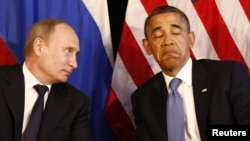 Russian President Vladimir Putin (left) speaks with U.S. President Barack Obama at a G20 summit in Los Cabos, Mexico in June.