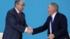 Kazakhstan's then-interim President Qasym-Zhomart Toqaev (left) shakes hands with former President Nursultan Nazarbaev in Nur-Sultan in April 2019.