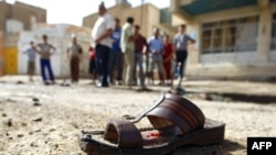 A shoe lies on the ground near the site of a suicide bomb at a mosque in New Baghdad.