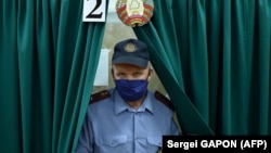 A police officer leaves a voting booth during early voting for the presidential election in the town of Hlybokaye, north of Minsk, on August 4.