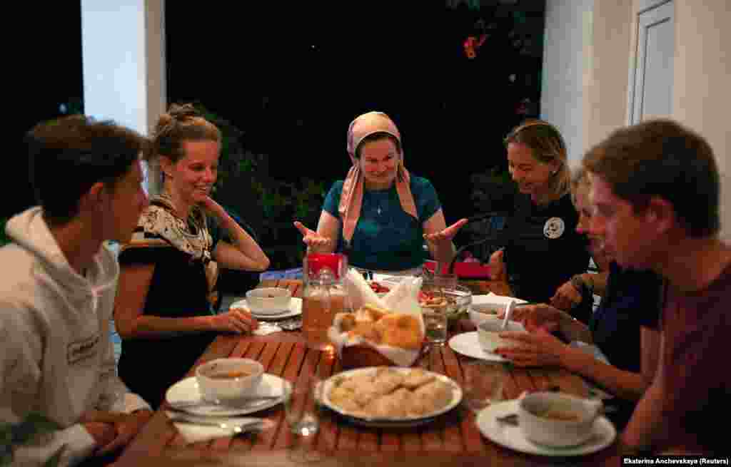 Leila Achishvili (center), a guesthouse owner in Jokolo whose two sons were killed fighting in Syria, at dinner with tourists. Photographer Anchevskaya told RFE/RL: &ldquo;In Pankisi, they say if you are a guest of someone in the village, you are the guest of the whole village. These people have been through a lot and still face prejudice and conflicts, but they respect their guests, traditions, and nature they live in, and they want to share it with others.&rdquo; 