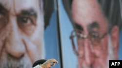 Iranian President Mahmud Ahmadinejad speaks before massive portraits of Ayatollah Ruhollah Khomeini (left) and Ayatollah Ali Khamenei in Tehran in 2008.