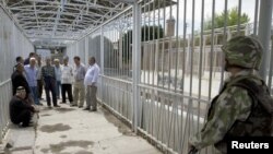 In the days following the worst of the Kyrgyz violence, ethnic Uzbeks waited on a bridge across the Kara-Su border river between Kyrgyzstan and Uzbekistan.