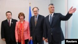 Serbian Prime Minister Ivica Dacic, European Union foreign policy chief Catherine Ashton, NATO Deputy Secretary-General Alexander Vershbow, and Kosovar Prime Minister Hashim Thaci (left to right) pose at NATO headquarters in Brussels on April 19, when the deal was initialed.