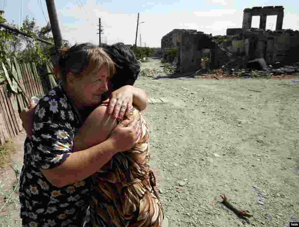 Women embrace amid ruins in Tskhinvali, which was largely destroyed in the fighting. 